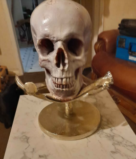 Decorative skull on ornate metallic stand